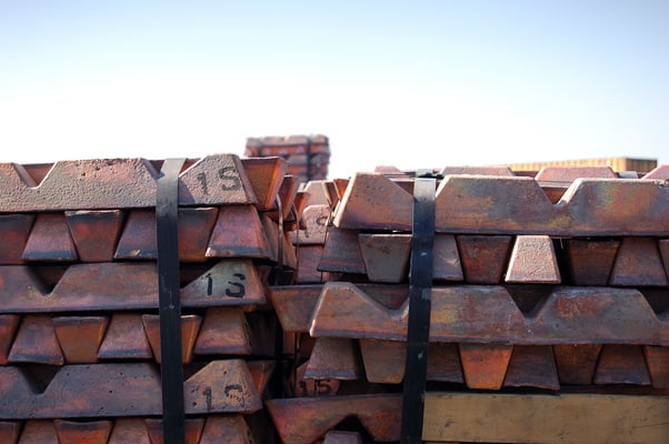 Several stacked copper bars outside